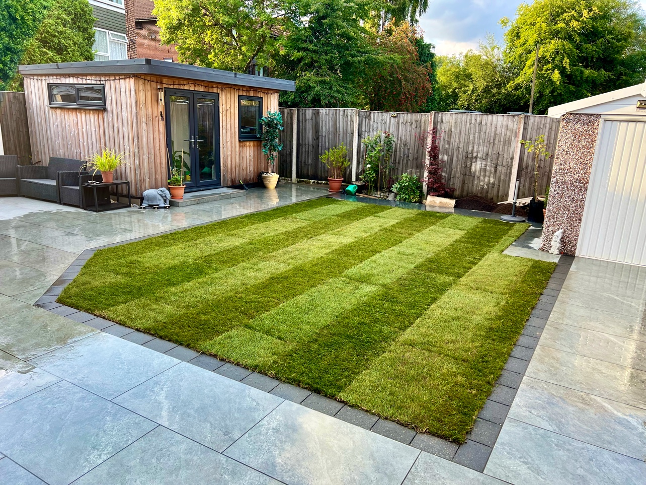 New turf framed by porcelain paving