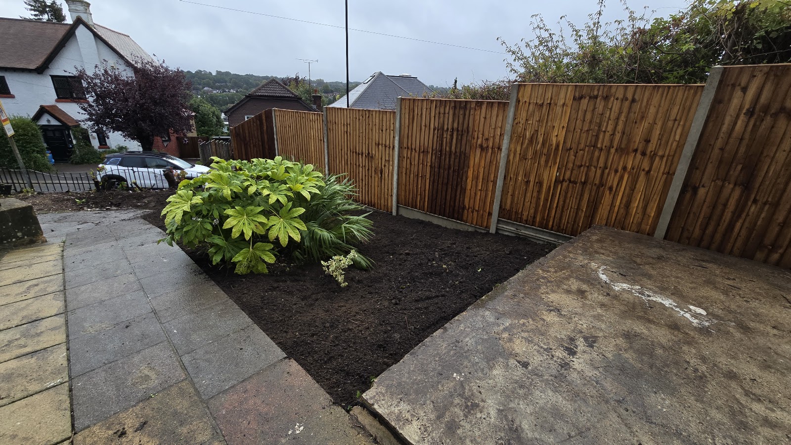 More than turf: new close-board fencing, a cleared and edged planting bed and fresh topsoil, finishing the whole garden.